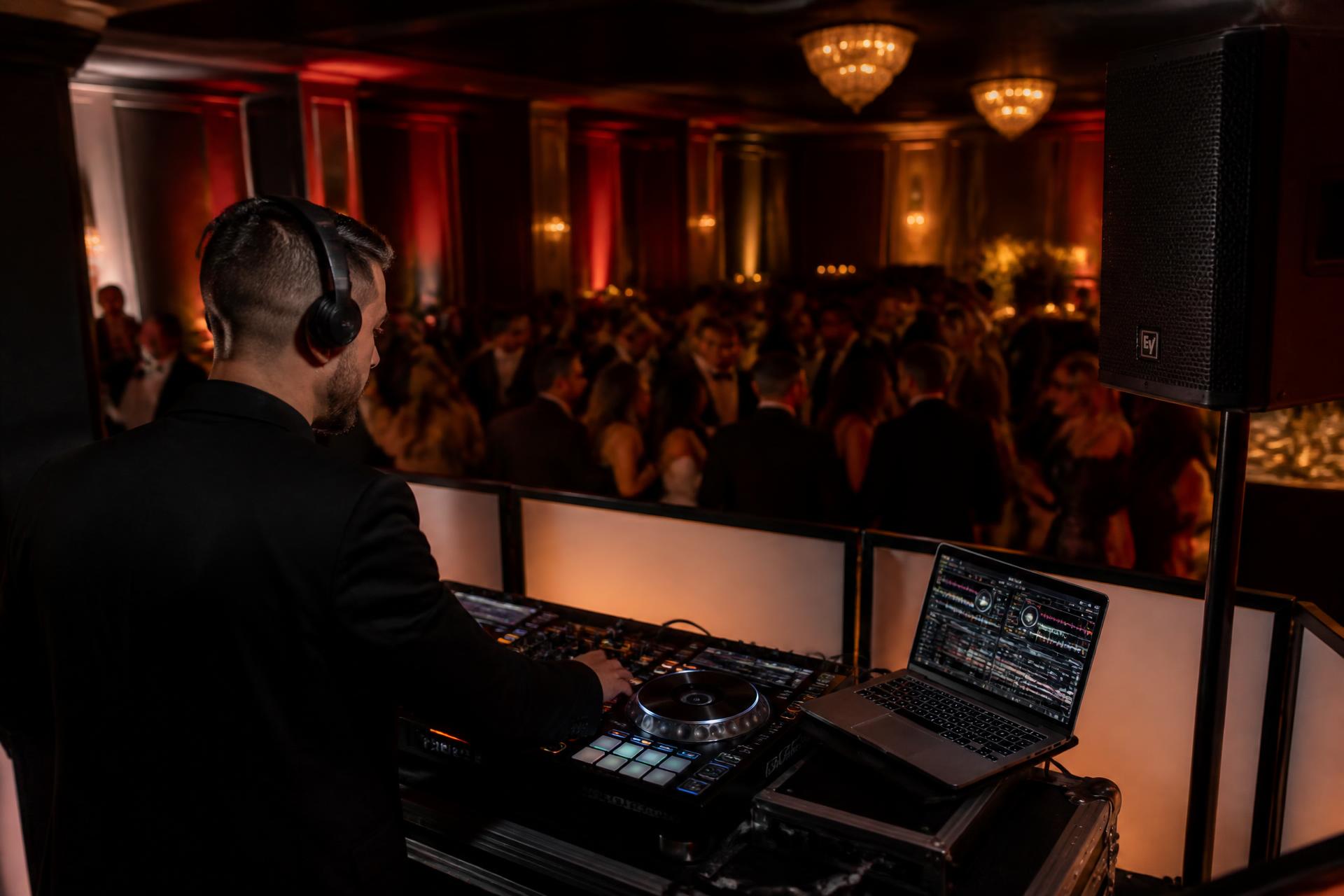 A mobile DJ setup with sound and lighting at an evening event
